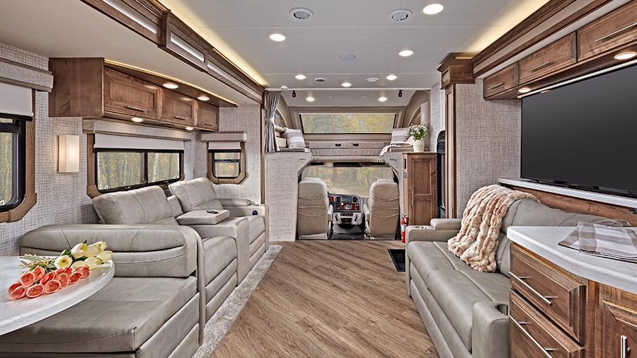 Accolade 37M Front Interior | The Accolade has a custom-molded ABS surround in the cab-over area with an overhead bunk with a 750 lb. capacity and safety net with a 300 lb. capacity. Once in the bunk, enjoy the view out the automotive-bonded panoramic window with power shade in (37M Shown).