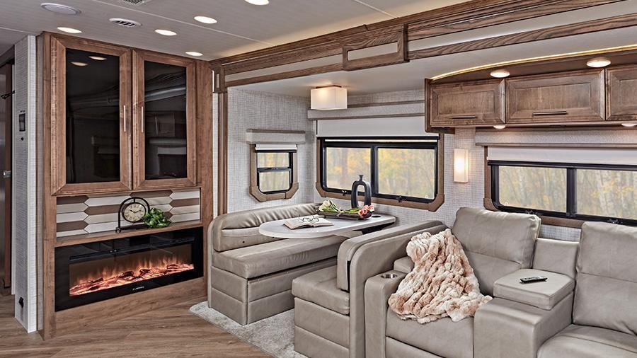 Accolade 37M Hutch and Dinette | Eat beside the hutch with electric fireplace in the Entegra-exclusive, easy-operation legless dinette table with car seat tethers in forward-facing positions, or relax in the Accolade 37M power theater seating with cupholders and recline function. 
