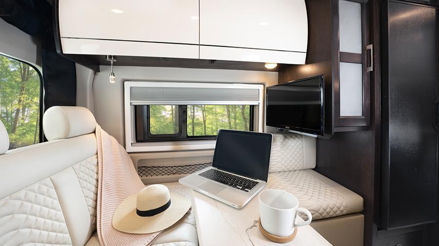 Expanse 21B Rear Interior | The Expanse 21B is sleek and stunning with Tecnoform European-style, high-gloss cabinetry, a soft-touch vinyl ceiling, high-intensity LED ceiling lights and a 24-inch LED HD TV.