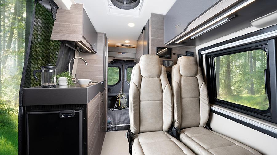 Launch 19Y Interior | The Launch 19Y interior features a dual bench seat with two seatbelts and slide/recline features, high-intensity LED ceiling lights, durable rubber flooring and the Firefly Multiplex system with wall-mounted touchscreen and mobile app for total coach control.