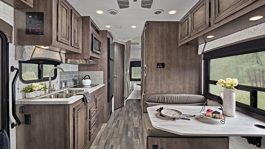 Odyssey SE 22C Rear Interior | The 2024 Odyssey SE 22C interior has an 84-inch ceiling height, high-intensity recessed LED lights, an LED-lit slideout fascia, pleated blackout shades and hardwood cabinet doors and drawer fronts. 