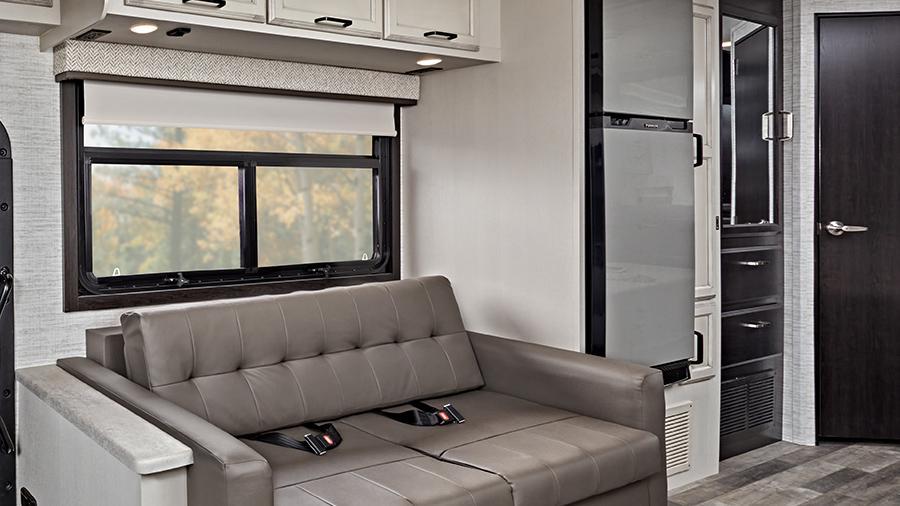 Vision 27A Sofa and Refrigerator | A sofa offers extra seating (two-point lap safety belts in all designated seating locations) in the Vision 27A, while the 10-cubic-foot 12V refrigerator sits across from the kitchen for easy-access. 