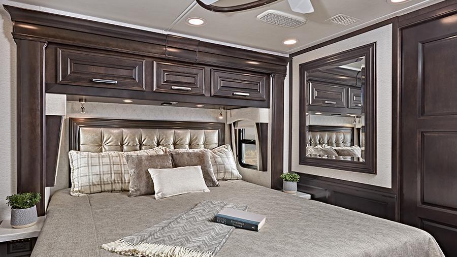Anthem 44W Bedroom | Find a restful night’s sleep in the Anthem 44W bedroom with Personal Comfort A5 king size mattress and residential-style headboard, a ceiling fan and nightstands with solid-surface tops.