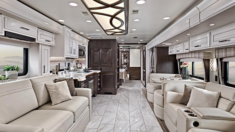 Anthem 44W Rear Interior | Luxuriously appointed, the Anthem 44W features hand-laid porcelain tiled floors, LED interior lighting, a decorative ceiling feature with integrated accent lighting, powered solar day and blackout night shades and Spyder 3.5 inch touchscreen switches throughout. 