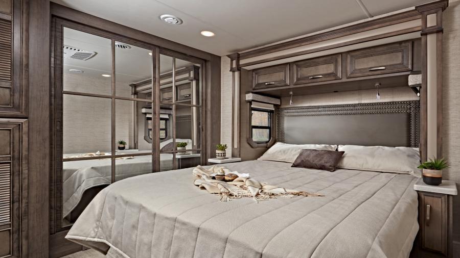 Experience relaxation at its best in the Emblem bedroom with a walk-around, king size bed and nightstands featuring built-in USB ports and wireless charging. (36H Shown)
