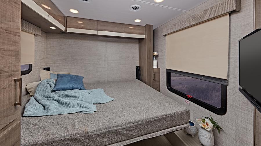 Find yet another sleeping area in the Entegra Qwest with a queen size Murphy bed that transforms the living area into another sleeping space. Day/night roller shades provide views during the day and privacy at night. (24N Shown)