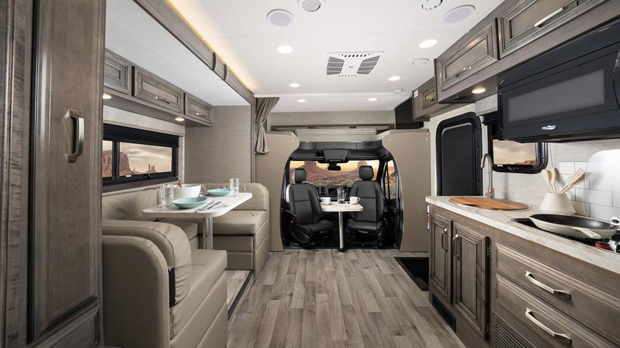 Qwest SE 24L Front Interior | Swivel driver and passenger seats turn to create a space for conversation in the Qwest SE 24L. A removable table is the perfect space for books, work or drinks once you’re parked at your destination. 