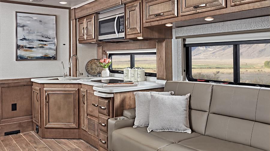 Reatta 39BH Kitchen and Hide-a-Bed | The hide-a-bed sofa next to the kitchen in the Reatta 39BH is a lovely place to sit when in the up position and provides additional sleeping space at night. 